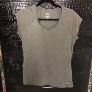 Women’s grey Nike dri-fit T-shirt. Some rushing at the bottom hem on both sides